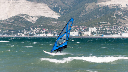 seascape with windsurfing. a windsurfer rides on the waves catching the wind with a sail. the sea,...