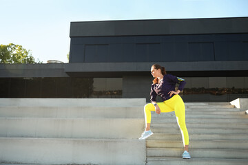 Sporty young woman training outdoors
