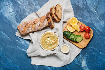 Bowl with tasty baba ghanoush and products on color background