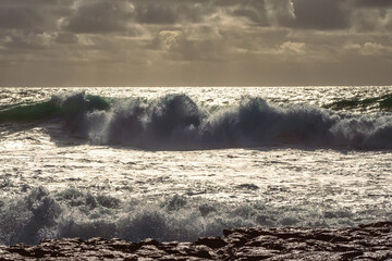 View on powerful high ocean waves of Atlantic ocean. Doolin, county Clare, Ireland. Nature rough power and energy concept. Dramatic light