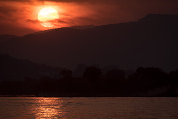 Dramatic close up landscape photograph of Sunset at lake Pichola in Udaipur, Rajasthan