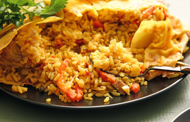 Plate with tasty Shah Pilaf on color wooden background, closeup
