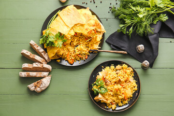 Plates with tasty Shah Pilaf and bread on color wooden background
