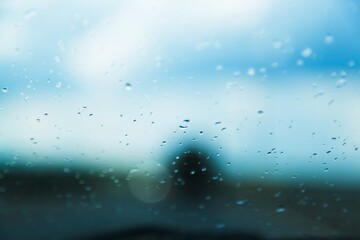 Many rain drops on a car glass.
