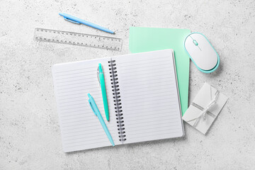 Stationery supplies and computer mouse on light background