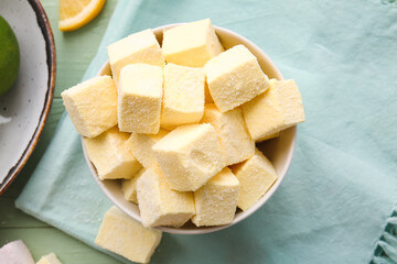 Bowl with tasty sweet marshmallows on color wooden background