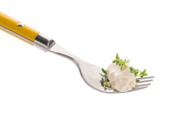 Fork with delicious gnocchi, creamy sauce and thyme on white background