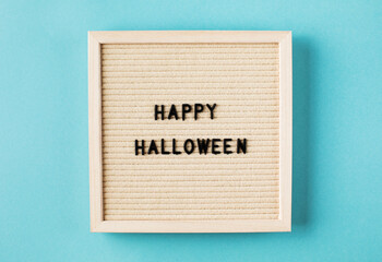 Greeting card with words Happy Halloween on blue color