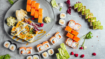 Top view of colorful sushi rolls, Japanese sushi set on bight stone table, Vegan sushi with vegetables, sushi shop