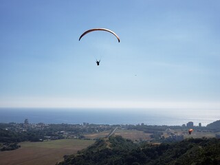 Fototapeta na wymiar Paragliding in Costa Rica in summer with the sea in the background