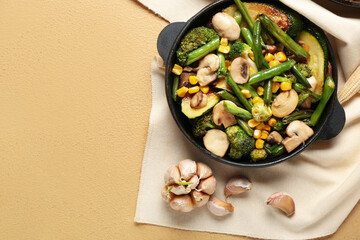 Frying pan with different vegetables on color background