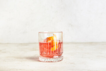 Glass of tasty Negroni cocktail on light background