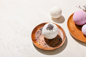 Plates with lavender bath bombs on light background, closeup