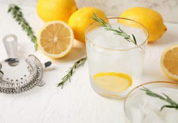 Glasses of cold gin tonic on light background