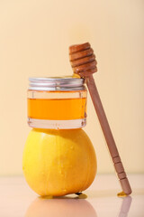 Jar of cosmetic product, honey, apple and dipper on color background