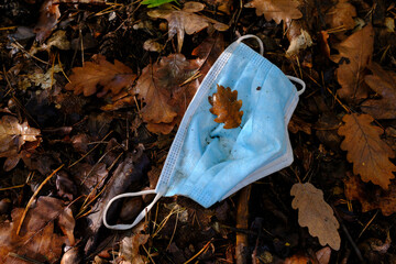 Corona face mask lost or discarded in nature.
