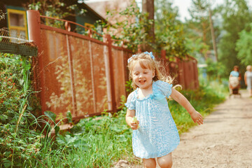 daughter runs towards her mother on the grass