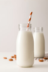closeup bottle of milk with straw on table.
