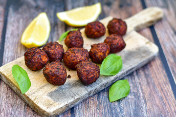 Home made deep fried   mini  fish and vegetables meatballs ,on  rustic background