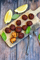 Home made deep fried   mini  fish and vegetables meatballs ,on  rustic background