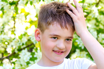 Outdoor portrait of boy making facepalm gesture in nature. boy struck by a wacky situation