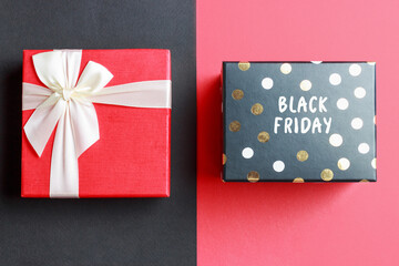 Gift box with Black Friday inscription on red background.