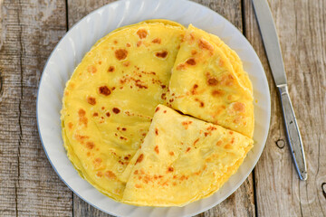 Bakery. Home made pancakes with   organic free range  eggs and white cheese on wooden background. Rustic style breakfast