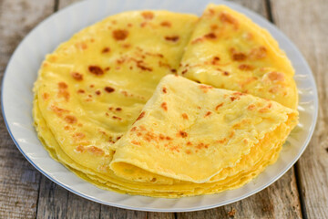 Bakery. Home made pancakes with   organic free range  eggs and white cheese on wooden background. Rustic style breakfast
