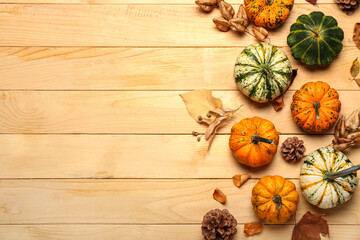 Fototapeta na wymiar Autumn composition with pumpkins on wooden background, closeup