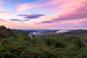 Low clouds and dramatic colours in the sky over the Devils Punch Bowl during sunset on the Surrey Hills near Hindhead south east England