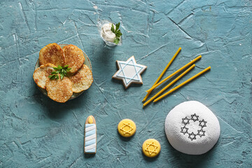 Different symbols of Hanukkah on color background