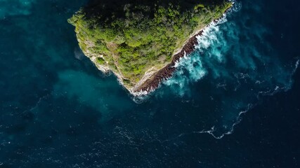 Top down view on small island in azure ocean in Bali Idonesia. High quality 4k aerial birdseye footage - Powered by Adobe
