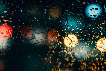 Rain Humidity night traffic lights of big city, rain drops on car windshield glass, focus on...