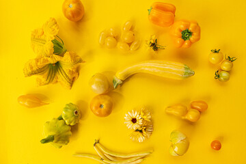 Yellow vegetables on the yellow background
