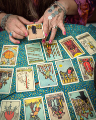 Psychic readings and clairvoyance concept - Fortune teller with hands hold death Tarot card.  Reading tarot divination