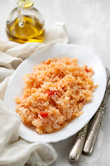 boiled rice with tomato and spices on white dish