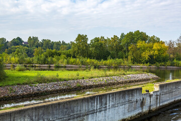Fototapeta premium View of the picturesque river and wooded autumn coast