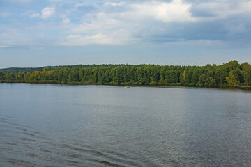 View of the picturesque river and wooded autumn coast
