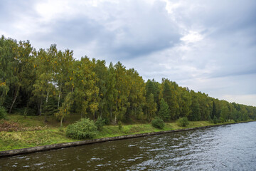 View of the picturesque river and wooded autumn coast