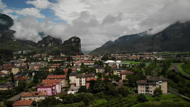 4K drone footage over village with mountains on the back in Arco, Italy.
Mid angle, traveling movement.