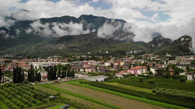 4K drone footage over village with mountains on the back in Arco, Italy.
Mid angle, traveling movement.