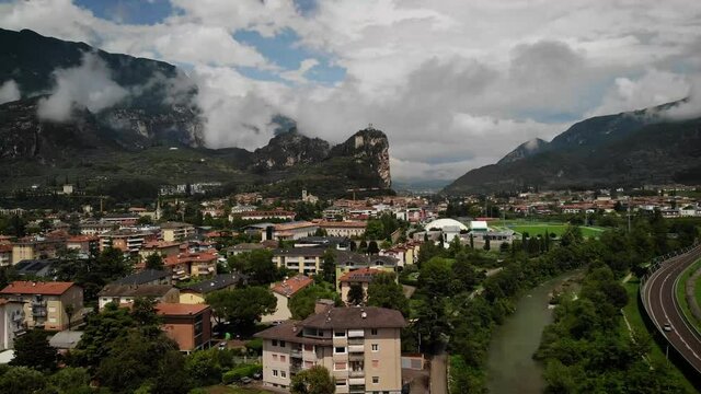 4K drone footage over village with mountains on the back in Arco, Italy.
Mid angle, traveling movement.