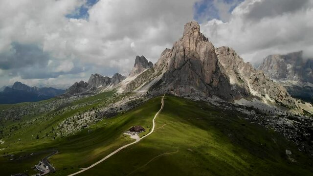 4K drone footage over mountain hut with mountain range on the back in Passo di Giau, Dolomites, Italy.
Mid angle, parallax movement.