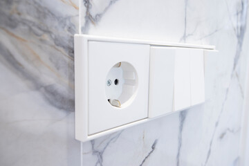 European socket on marble surface
