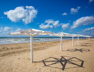 Empty beach with white umbrellas. Black sea