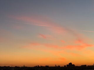 Clouds and sky in different situations and colors. Romantic mood. City buildings and monuments on the background of the sky. City sky. Pink and orange clouds. Sky at sea, sunsets and sunrises.