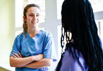 Nurses having a conversation in the hospital hallway