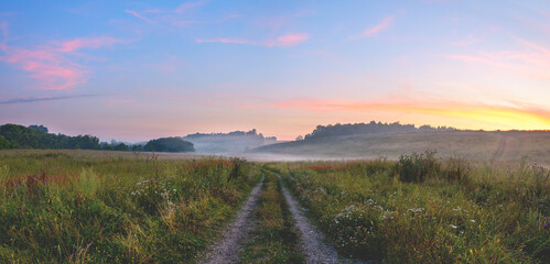 Fototapeta na wymiar Foggy landscape with rural road