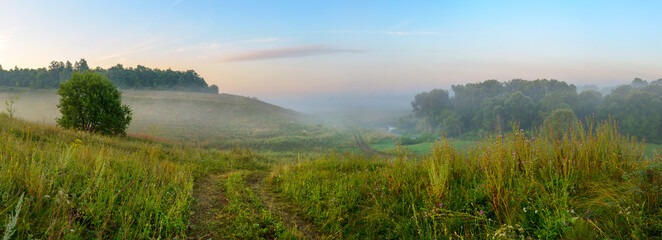 Obraz premium sunrise over the green hills