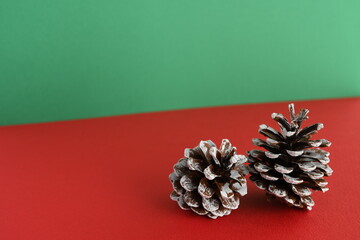 Christmas pinecones on red and green background.